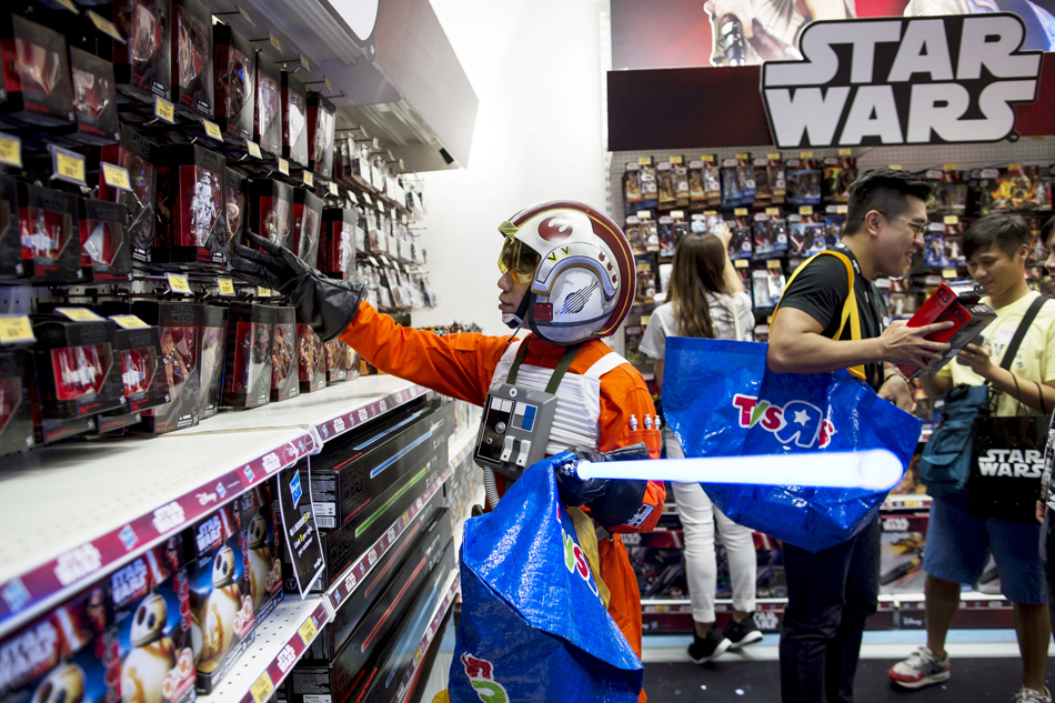a fan dressed up as luke skywalker picks new toys from the upcoming film quot star wars the force awakens quot on quot force friday quot after the launch of the film 039 s new toys in hong kong china september 4 2015 photo reuters