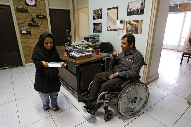 iranian fatemeh taqizadeh works at her office at the bavar quot belief quot non governmental organisation that helps people with disabilities in tehran photo afp