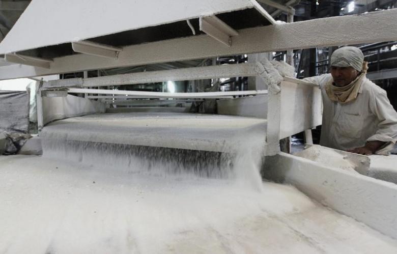 a worker checks the flow of sugar inside a sugar factory photo reuters