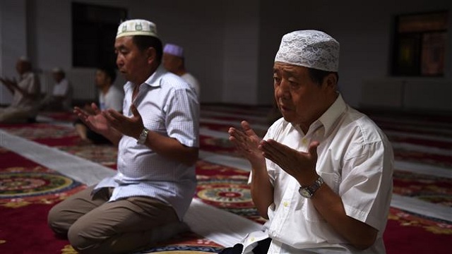 chinese muslims pray after breaking their fast on the first day of ramadan at a mosque photo presstv