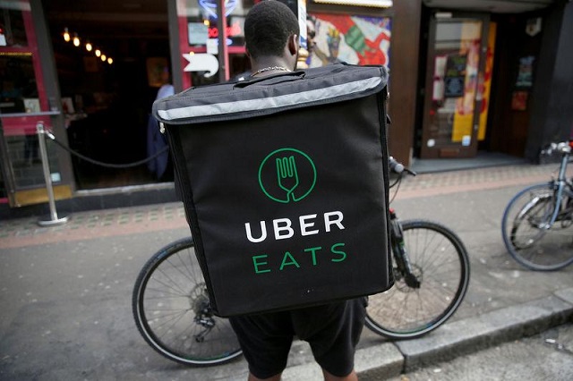 an ubereats food delivery courier stands in front of his bike in london britain september 7 2016 photo reuters