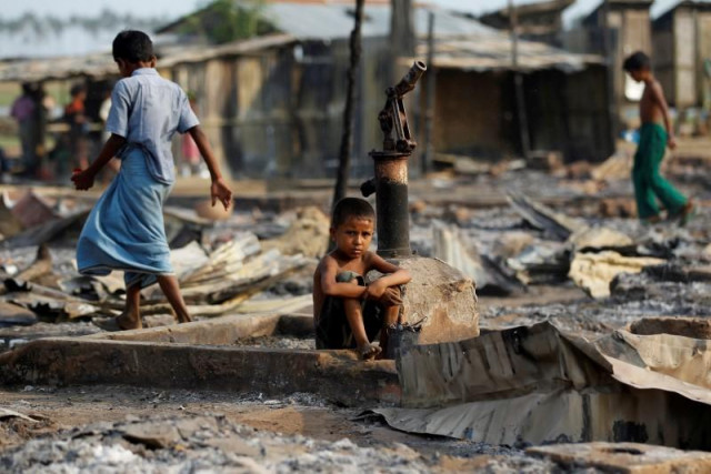 a boy sit in a burnt area after fire destroyed shelters at a camp for internally displaced rohingya muslims in the western rakhine state near sittwe myanmar photo reuters a boy sit in a burnt area after fire destroyed shelters at a camp for internally displaced rohingya muslims in the western rakhine state near sittwe myanmar photo reuters