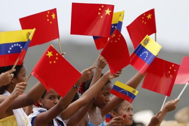venezuelan children wave flags as they welcome china 039 s president xi jinping at simon bolivar airport photo reuters