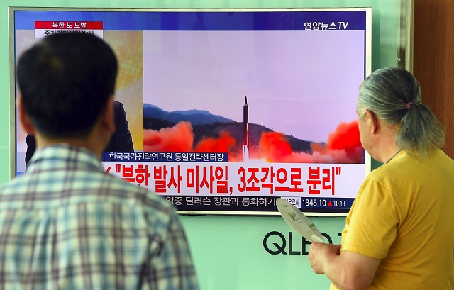 people watch a television news screen showing file footage of a north korean missile launch at a railway station in seoul on august 29 2017 nuclear armed north korea fired a ballistic missile over japan and into the pacific ocean on august 29 in a major escalation by pyongyang amid tensions over its weapons ambitions photo afp