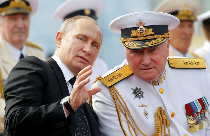 russian president vladimir putin speaks with commander in chief of the russian navy admiral vladimir korolev at the navy day parade in st petersburg russia july 30 2017 photo reuters