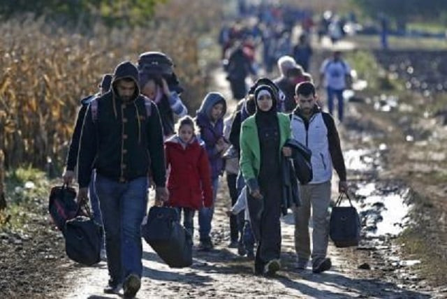 migrants carry their belongings as they walk to cross the border into croatia near sid serbia october 2 2015 photo reuters dado ruvic migrants carry their belongings as they walk to cross the border into croatia near sid serbia october 2 2015 photo reuters dado ruvic