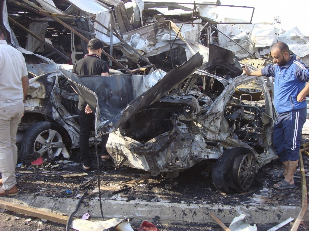 people inspect the site of a car bomb attack in baghdad 039 s al mashtal district november 17 2014 photo reuters