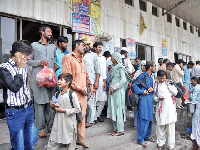 people wait at a local bus stop to reach their hometowns ahead of eidul azha photo app people wait at a local bus stop to reach their hometowns ahead of eidul azha photo app