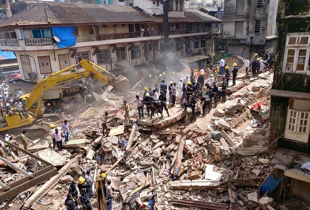 firefighters and rescue workers search for survivors at the site of a collapsed building in mumbai india photo reuters