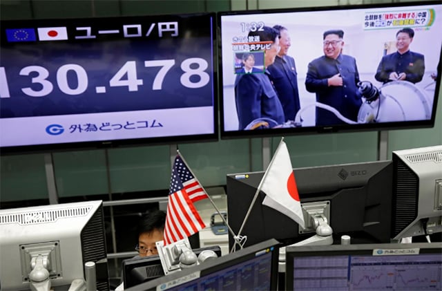 an employee of a foreign exchange trading company works near monitors showing tv news on north korea 039 s nuclear test right in tokyo japan september 4 2017 photo reuters