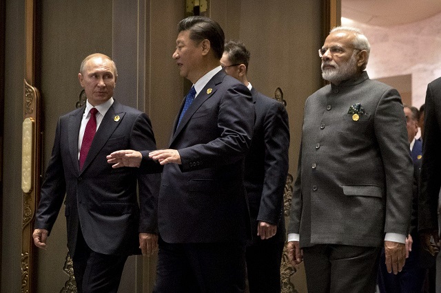 l to r russian president vladimir putin chinese president xi jinping and indian prime minister narendra modi arrive for the dialogue of emerging market and developing countries on the sidelines of the 2017 brics summit in xiamen southeastern china 039 s fujian province on september 5 2017 xi opened the annual summit of brics leaders that already has been upstaged by north korea 039 s latest nuclear weapons provocation photo afp