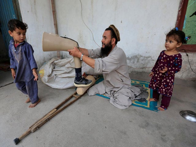 khushhal khan ayobi 34 a disabled afghan national army ana soldier fits his artificial limb at his house in jalalabad province afghanistan august 2 2017 photo reuters