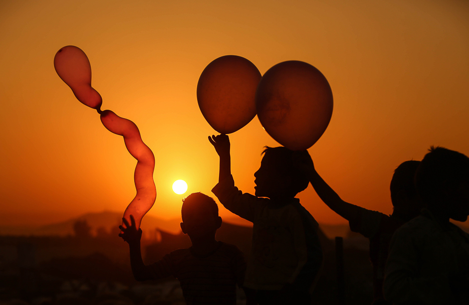 syrian children play with balloons in the rebel held town of douma on the eastern outskirts of damascus photo afp