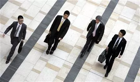 businessmen walk on a street photo reuters businessmen walk on a street photo reuters
