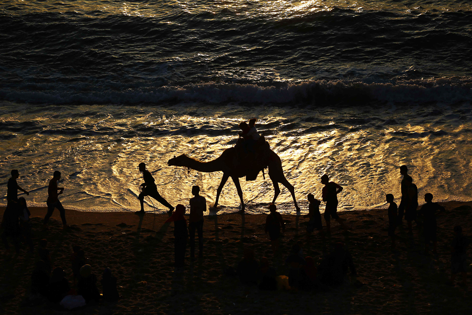 palestinians spend time at the beach at sunset in gaza city photo afp