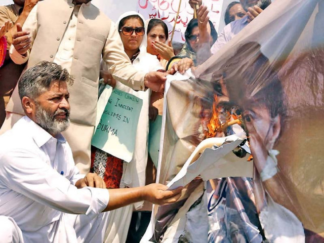 activists burn a poster of myanmar s state counsellor aung san suu kyi while protesting outside the national press club photo online activists burn a poster of myanmar s state counsellor aung san suu kyi while protesting outside the national press club photo online