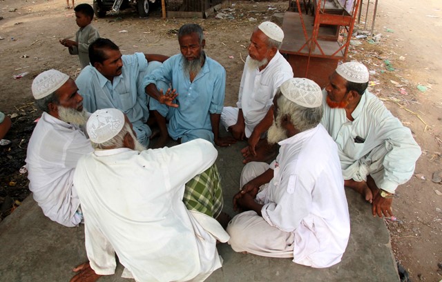 a group of rohingya men talk amongst themselves near a tea shop in a karachi neighbourhood photo athar khan express