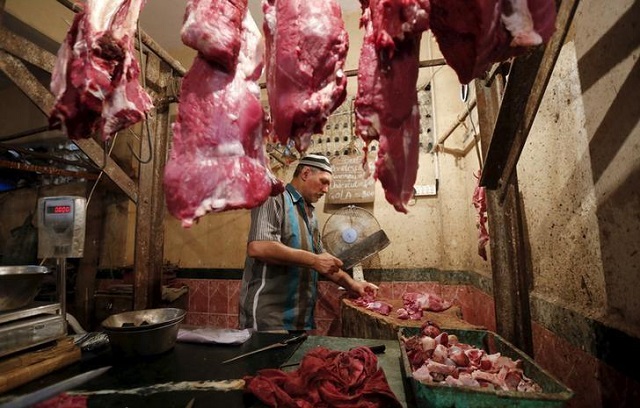 a butcher cuts meat for a customer inside his shop in mumbai september 8 2015 photo reuters shailesh andrade