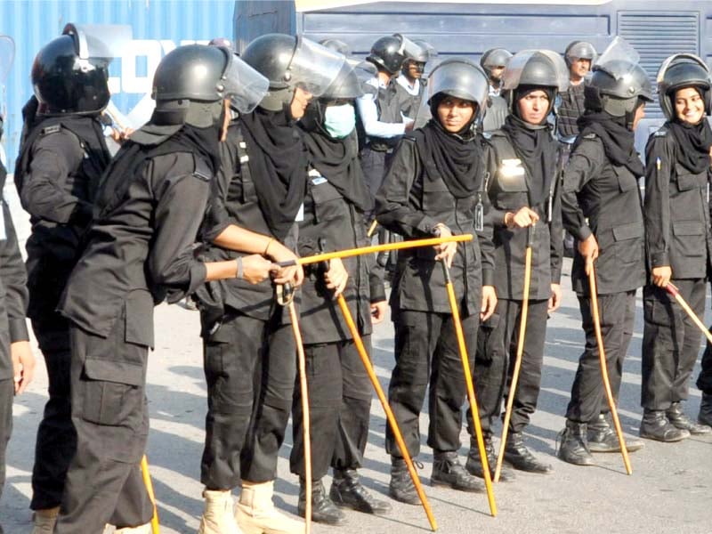 a contingent of women police in riot gear looks on anti myanmar protesters gather near the red zone photo zafar aslam express