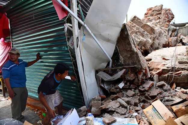 survivors standing near the rubble of a building in juchitan de zaragoza after it was destroyed by mexico 039 s worst earthquake in over a century photo afp