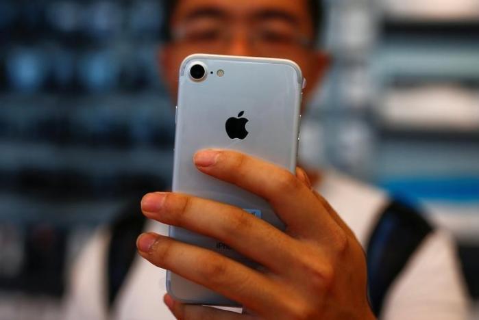 a man holds his new iphone 7 at an apple store in beijing photo reuters