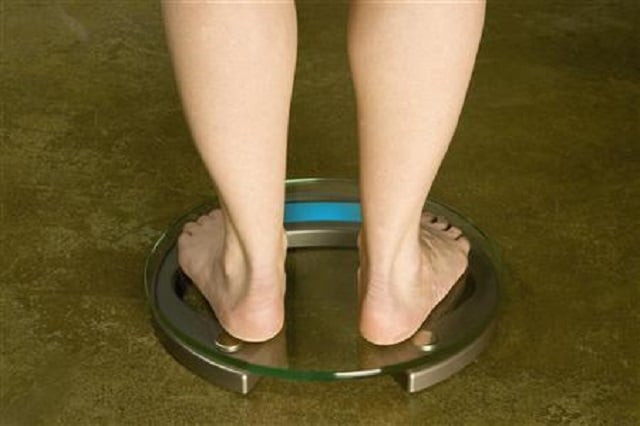 a person stands on a weight scale in this undated handout image photo reuters a person stands on a weight scale in this undated handout image photo reuters