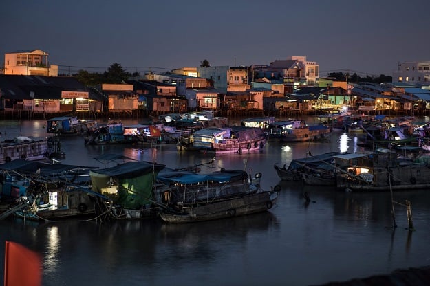 boats lie anchored in a canal off the song hau river in the floating cai rang market in can tho a small city of the mekong delta photo afp