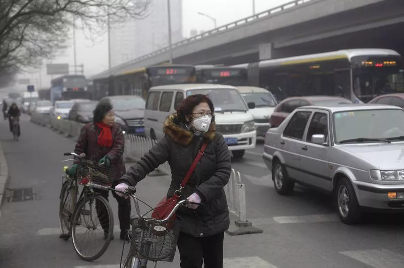 a woman c wearing a mask stands besides her bicycle as vehicles stop at a traffic junction on a busy street amid thick haze in beijing in this february 25 2014 file photo photo reuters a woman c wearing a mask stands besides her bicycle as vehicles stop at a traffic junction on a busy street amid thick haze in beijing in this february 25 2014 file photo photo reuters
