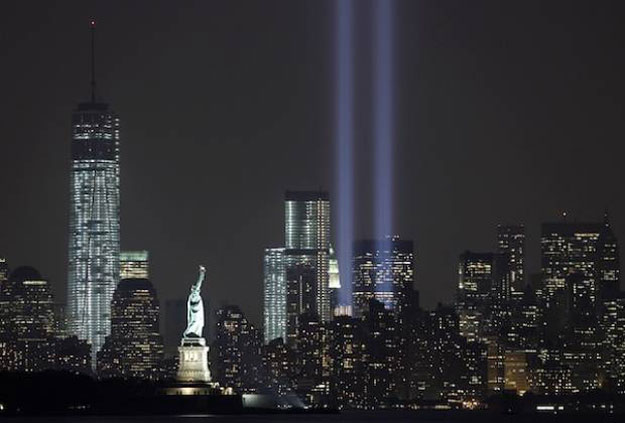 the tribute in light is illuminated next to the statue of liberty centre and one world trade centre left during events marking the 12th anniversary of the 9 11 attacks on the world trade centre in new york september 10 2013 photo reuters file