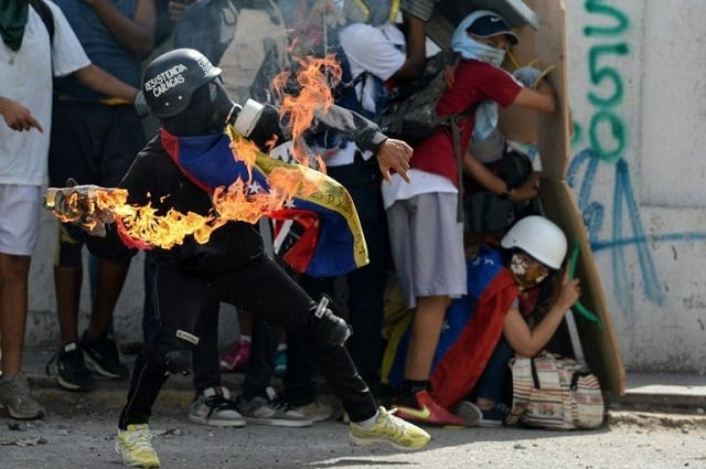 opposition activists clash with the police during a demonstration against venezuelan president nicolas maduro in caracas on july 9 2017 photo afp opposition activists clash with the police during a demonstration against venezuelan president nicolas maduro in caracas on july 9 2017 photo afp