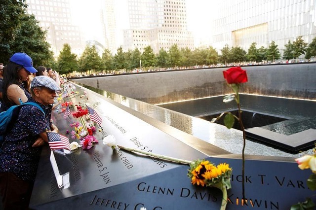 visitors look out over the national september 11 memorial and museum on the 15th anniversary of the 9 11 attacks in manhattan new york us on september 11 2016 photo reuters lucas jackson file photo