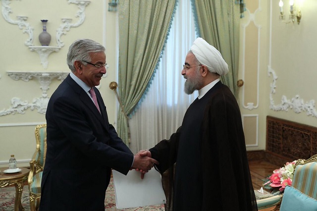 foreign minister khawaja asif shakes hands with iranian president hassan rowhani photo pid