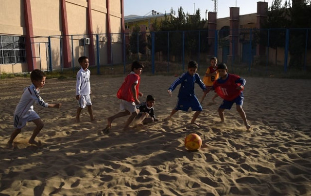 afghan youths gather to play beach football at ghazi stadium in kabul photo afp afghan youths gather to play beach football at ghazi stadium in kabul photo afp