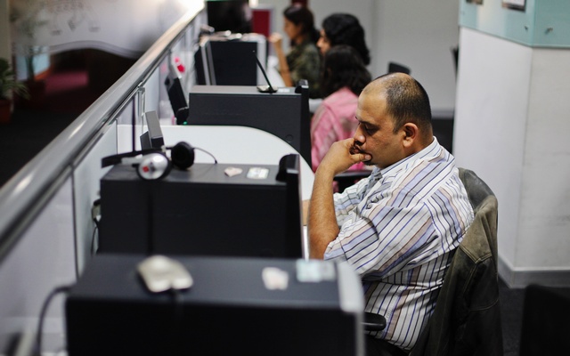 office workers sit in front of their workstations on the floor of an outsourcing centre in bangalore february 29 2012 photo reuters
