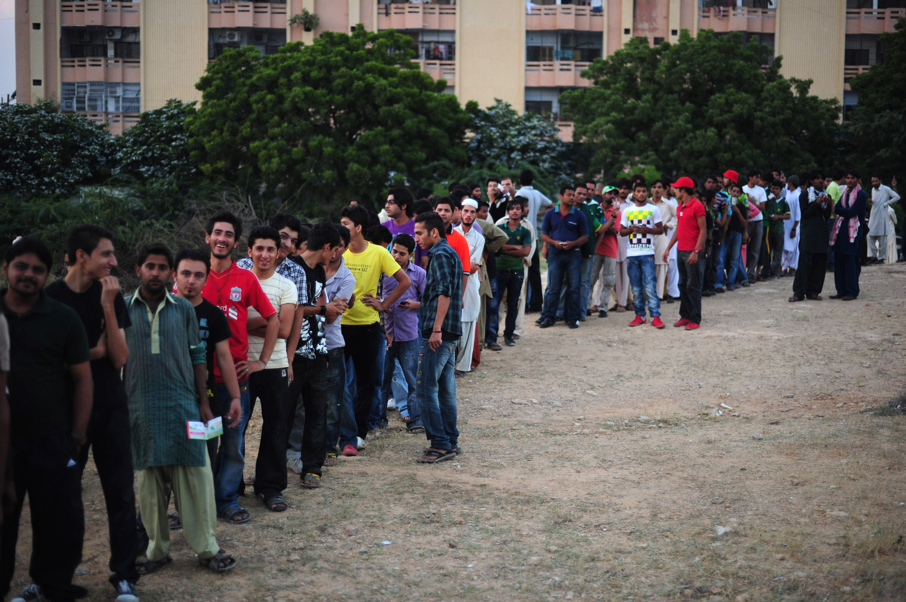 pakistani cricket fans queue outside the national stadium prior to the start of the twenty 20 match between international world xi and pakistan all stars cricket teams in karachi on october 20 2012 photo afp