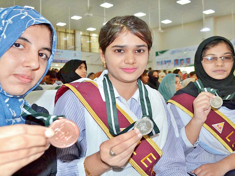 position holders showing medals at a ceremony in sargodha photo app