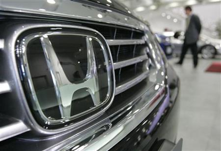 a man walks past honda motor co cars at a showroom in tokyo january 30 2008 photo reuters