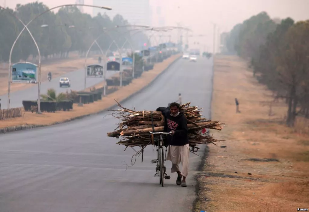 a man pushes a bicycle loaded with tree branches to be used for heating and cooking on a road in islamabad pakistan photo reuters a man pushes a bicycle loaded with tree branches to be used for heating and cooking on a road in islamabad pakistan photo reuters
