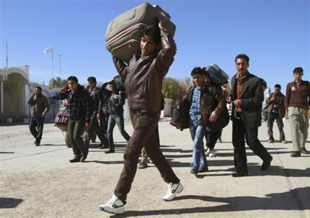 a group of afghan migrant workers enter afghan territory after leaving iran at the islam qala border in herat province photo reuters a group of afghan migrant workers enter afghan territory after leaving iran at the islam qala border in herat province photo reuters