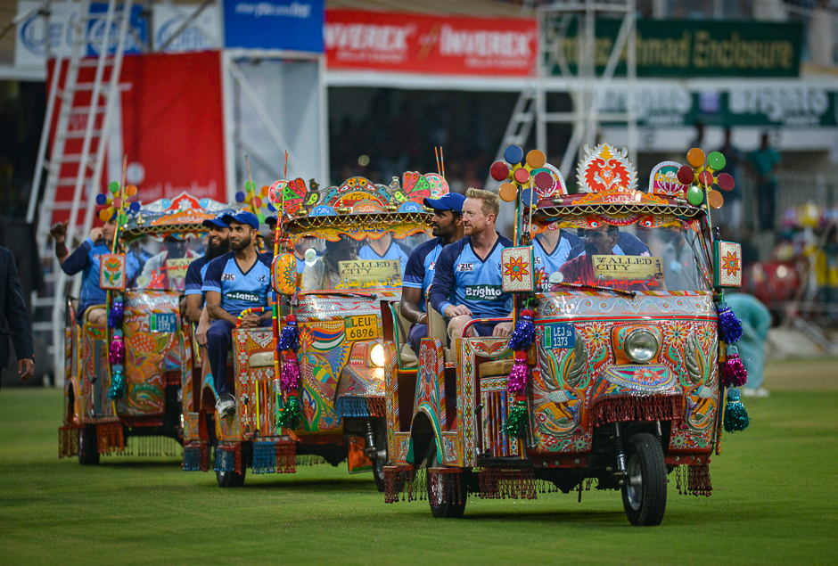 international world xi cricketers ben cutting r morne morkel c and imran tahir l sit in auto rickshaws as they acknowledge the crowd at the main entrance of the gaddafi cricket stadium in lahore photo afp