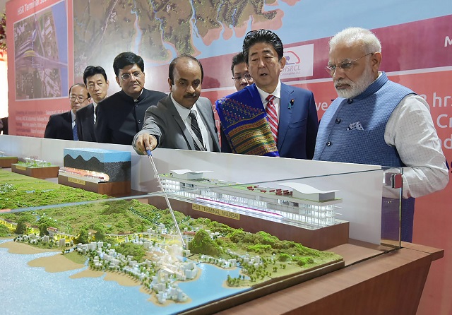 this handout photograph released by india 039 s press information bureau pib on september 14 2017 shows indian prime minister narendra modi l and japanese prime minister shinzo abe looking at a railway station model at a ground breaking ceremony for the mumbai ahmedabad high speed rail project in ahmedabad india 039 s first bullet train project a 19 billion initiative linking ahmedabad to mumbai was launched september 14 as indian prime minister narendra modi and japanese counterpart shinzo abe hailed fast growing ties between asia 039 s two biggest democracies photo afp