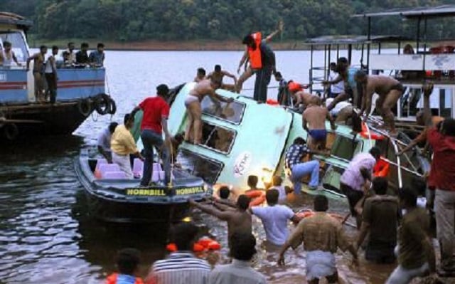 rescue workers stand over a capsized boat at a lake in a wildlife sanctuary at thekkady in the southern indian state of kerala september 30 2009 photo reuters