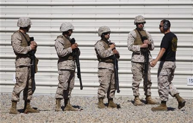 us marines work with an instructor on the firing range as they train to be a member of a fleet antiterrorism security team fast unit at a training ground in chesapeake virginia september 25 2012 photo reuters jonathan ernst