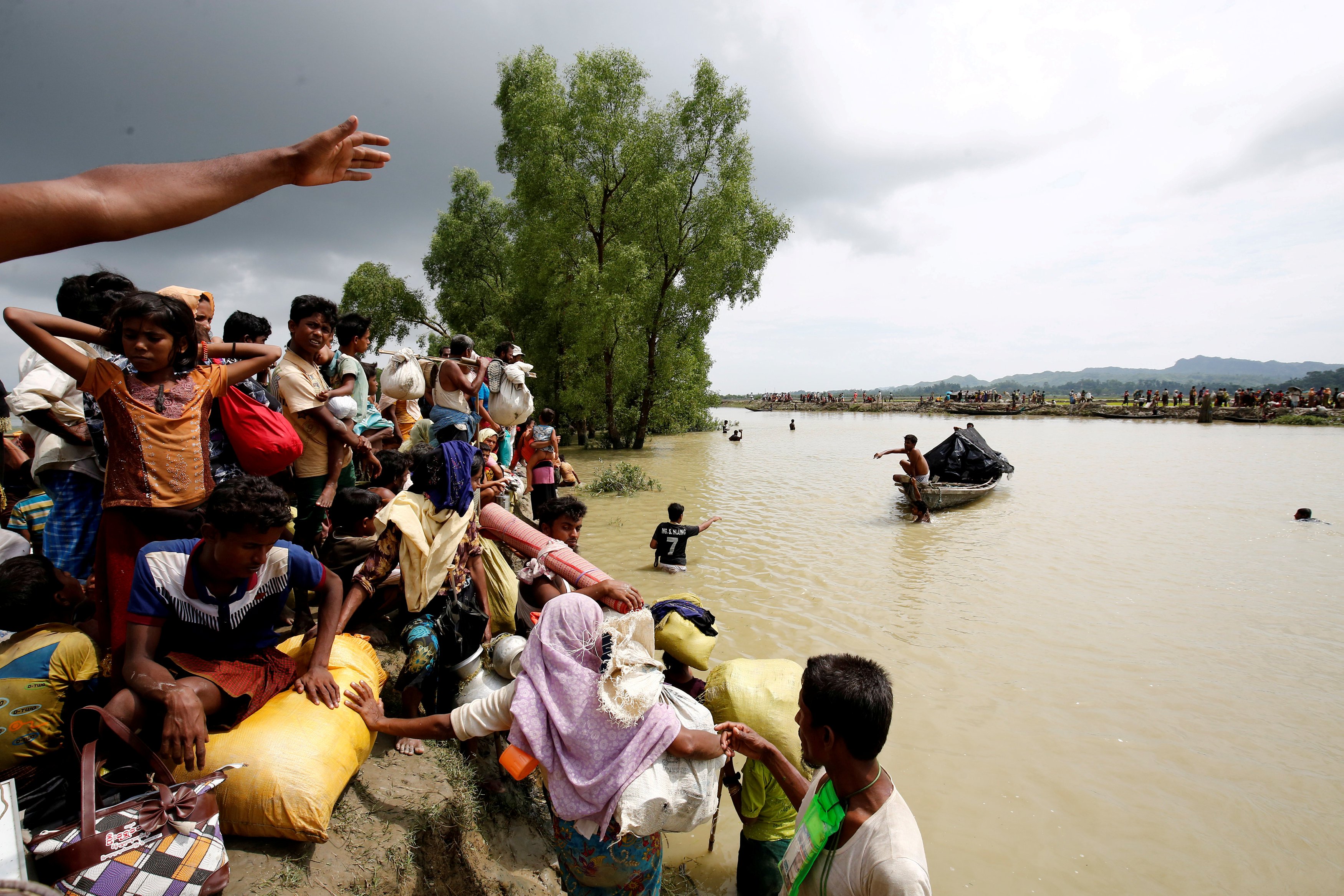 rohingya refugees wait for boat to cross a canal after crossing the border through the naf river in teknaf bangladesh photo reuters