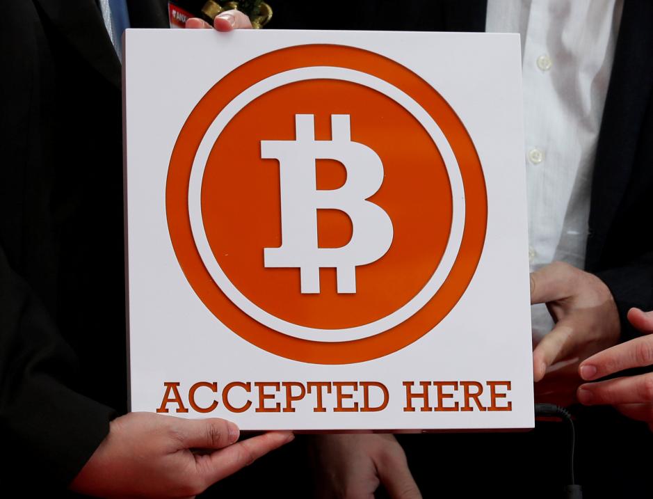 a bitcoin sign is held in hong kong february 28 2014 photo reuters