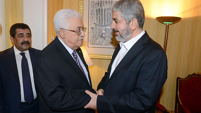 fatah leader and pa president abbas with hamas leader mashal in doha photo reuters