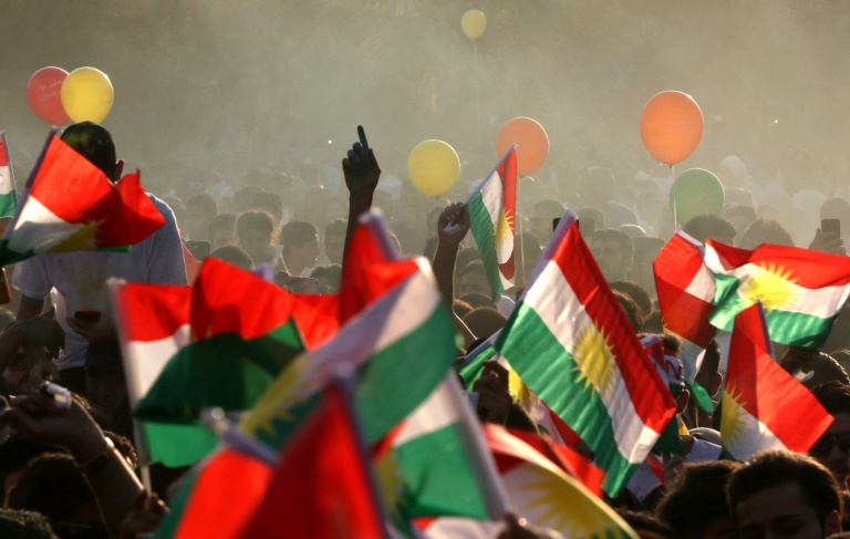 iraqi kurds fly kurdish flags during an event to urge people to vote in the upcoming independence referendum in arbil photo afp