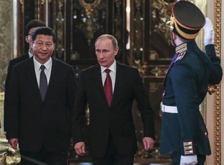 russia 039 s president vladimir putin c and his chinese counterpart xi jinping walk into a hall as they meet at the kremlin in moscow photo reuters