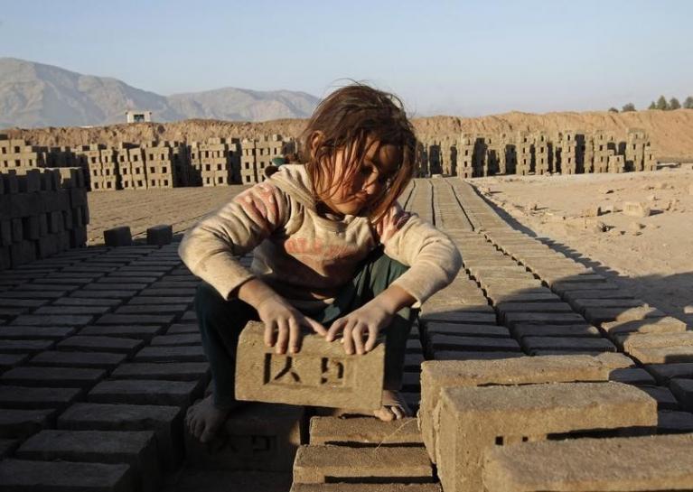 an afghan girl works at a brick making factory in nangarhar province photo reuters