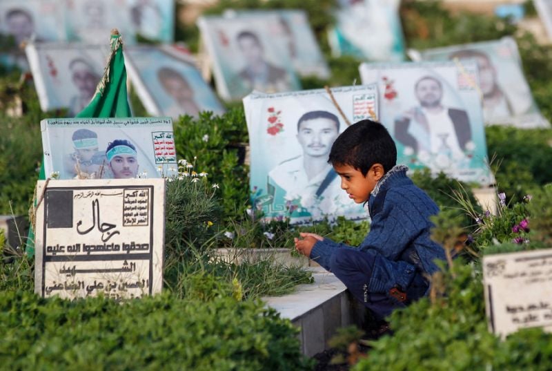 a yemeni child sits next to the grave of a loved one in the rebel held capital sanaa on september 1 2017 among more than 8 000 people who have been killed since a saud led coalition intervened to prop up the beleaguered government in march 2015 photo afp